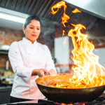 Chef preparing food over high heat in a professional kitchen, highlighting the intensity and complexity of F&B operations