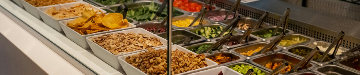 Prepared ingredients arranged in a central kitchen production line for efficient food preparation